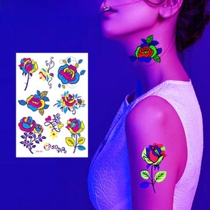Neon floral waterproof tattoo stickers featuring glowing roses on a model in dark light
