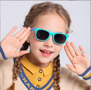 Detail of child wearing teal Wellington sunglasses with grey lenses and silver accents