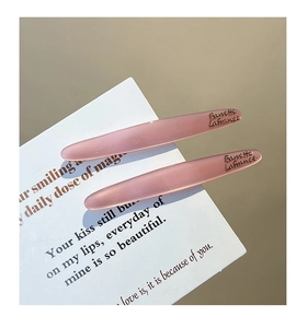 Detail of pink resin hair clips on a white card with Barrette LaFrance engraving
