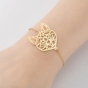 Minimalist gold stainless steel hollow cat pendant bracelet worn on a female wrist
