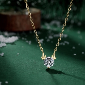Macro shot of gold deer antler pendant necklace with a large round cubic zirconia stone