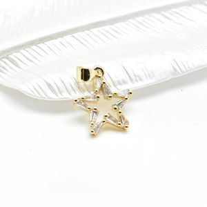 18k gold plated hollow star pendant with baguette cubic zirconia on a white tray