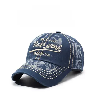 Close-up of vintage navy blue washed cotton baseball cap with white letter embroidery