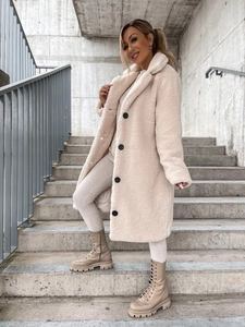 Detail of cream long plush teddy coat featuring wide lapels and contrast buttons