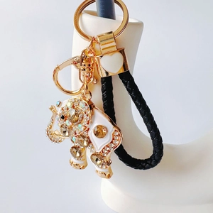 Detailed close-up of elephant keychain with crystal rhinestones and white enamel finish