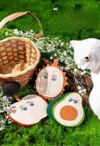Handmade felt fruit cat toys featuring durian, apple, and avocado shapes on green grass