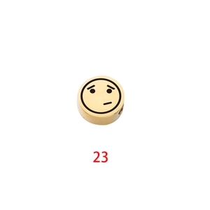 Close-up of golden cylinder bead with laser-engraved skeptical emoji face and red number 23