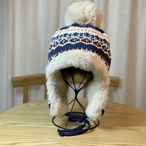 Jacquard knit trapper hat with ear flaps and warm faux fur lining for winter skiing