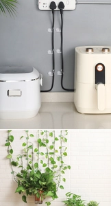 Macro detail of snail-shaped plant support clips and cable organizers on white wall