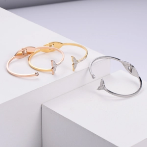 Elegant fishtail charm open bangles set in rose gold, gold, and silver finishes