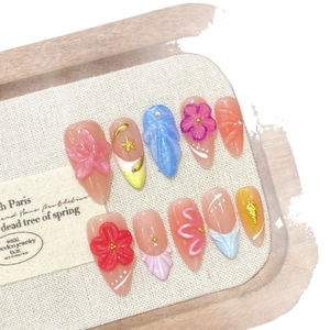 Handmade press-on nails set with 3D embossed floral patterns and blue gradient shell texture