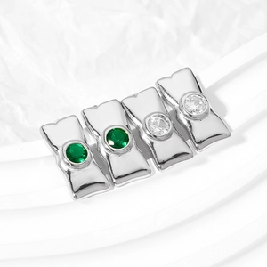 Bowtie geometric stainless steel earrings with green and white zircon on wave background
