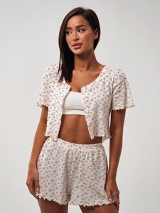 Detailed close-up of floral print pajamas set featuring ruffled edges and soft cotton fabric