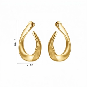 Detail view of gold twisted teardrop earrings showing 35mm height and 21mm width dimensions