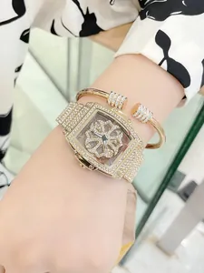 Close-up of luxury tonneau watch and bracelet set with rotating floral diamond dial