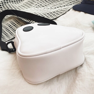Side view detail of a cute white ghost-shaped PU leather crossbody bag with black strap