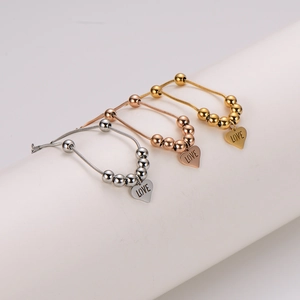 Three-tone heart charm bracelets with LOVE engraving on round snake chains in gold and silver