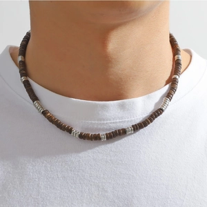 Detail of bohemian beaded necklace on model with brown wood and silver metal beads