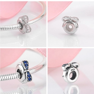 Detail of S925 sterling silver bow charms with pink and blue gemstones for bracelets