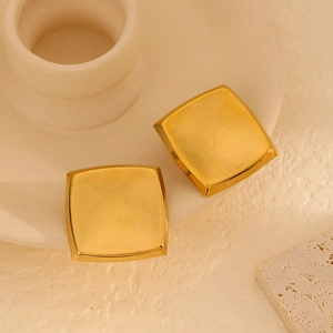 Minimalist square 18K gold plated stainless steel studs on elegant ceramic background