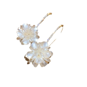 Floral pearl earrings with golden accents and crystal center on a clean white background
