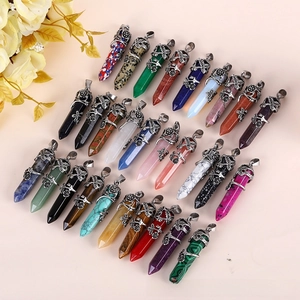 Detailed view of hexagonal crystal pendants with vintage silver floral metal wrap