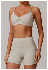 Detail of V-neck yoga bra and high waist shorts set with pleated texture and cross back
