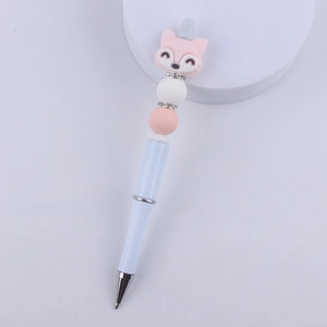 Close-up of beaded ballpoint pen featuring pink cartoon fox and rhinestone metal rings