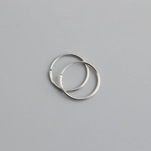 Minimalist S925 sterling silver hoop earrings shown from a top-down view on gray background