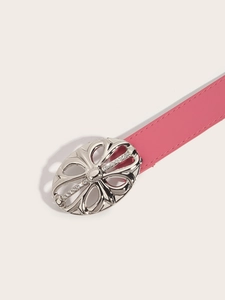 Close-up of pink leather belt with ornate silver floral buckle and sparkling rhinestones