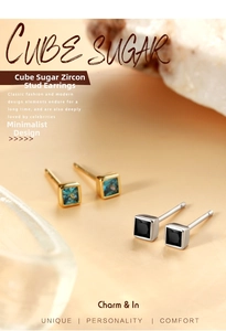 Macro shot of square zircon stud earrings in gold-blue and silver-black finishes