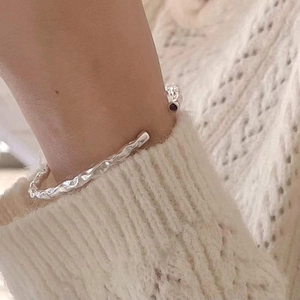 Minimalist 925 sterling silver open bangle featuring irregular matte lava texture