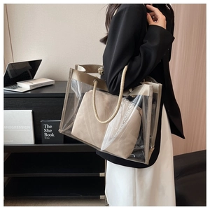 Detail of transparent PVC tote bag with beige inner pouch and thick rope handles