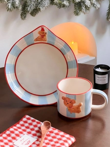 Detail of a ceramic mug and plate set featuring a 3D bear design and blue stripes