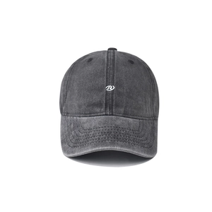 Close-up of small white circular embroidery and vintage washed cotton fabric on the cap