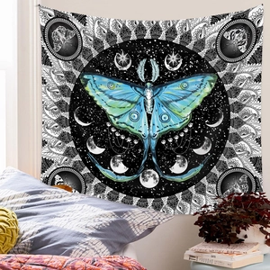 Bohemian tapestry featuring teal moth, moon phases, and monochrome mandala patterns