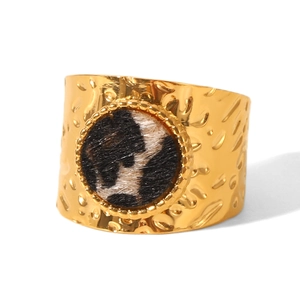 Detailed view of wide 18k gold plated ring with leopard print inlay and hammered texture