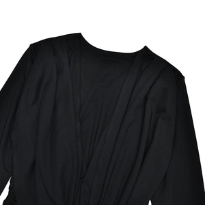 Detailed view of black long sleeve shirt with elegant draped neckline and soft fabric texture