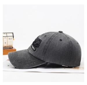 Detail of 3D New York City embroidery on a washed dark grey vintage cotton baseball cap
