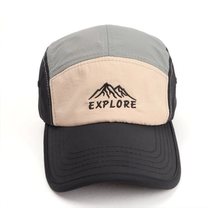 Detailed close-up of mountain embroidery and Explore text on five-panel dry-fit cap