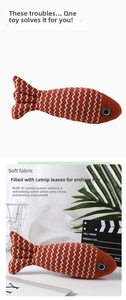 Catnip-filled fish cat toy made of soft orange fabric with white wave patterns