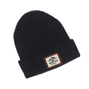 Detail of the black knit beanie with outdoor style WILD LIFE mountain patch and texture