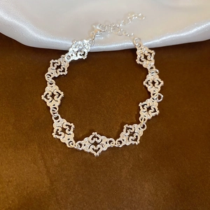 Close-up of silver hollow heart chain bracelet with lobster clasp and extension link