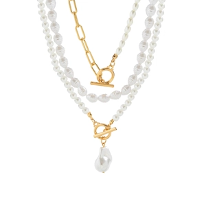 Detail of multi-layered pearl necklace featuring gold T-bar clasp and baroque pendant
