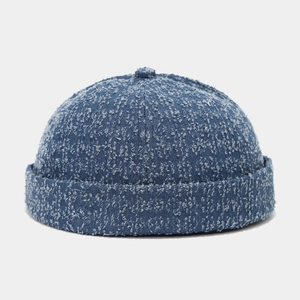 Close-up of blue washed denim docker hat showing retro industrial texture and fabric