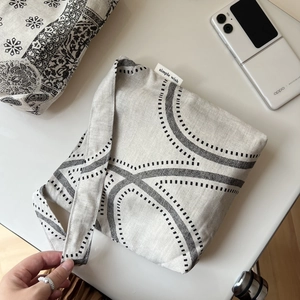 Close-up of retro cotton linen shoulder bag featuring geometric patterns and side label