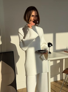 Women's white knitted set featuring high neck sweater and wide leg pants in a cozy style