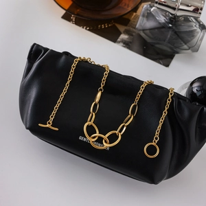 Chic black faux leather eyewear case with gold metal chain strap on white background