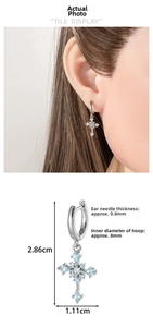 Detail view of silver cross earrings with light blue zircons and precise product dimensions