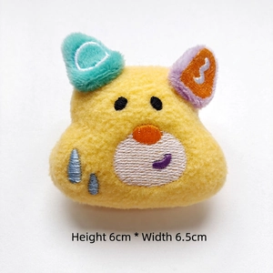 Detail of yellow plush dog charm with colorful ears and 6cm height embroidery detail